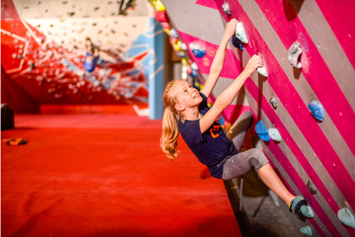 A child climbing a wall at Boulders.
